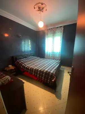 a bedroom with a bed with a checkered blanket at Marrakech house Your Haven of Peace in Marrakech in Marrakech