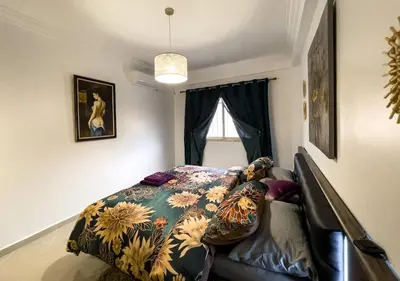 a bedroom with a bed with a blanket on it at Appartement privé au cœur de Marrakech in Marrakech