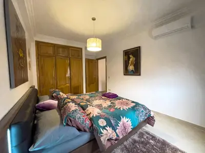 a bedroom with a bed with a blanket on it at Appartement privé au cœur de Marrakech in Marrakech
