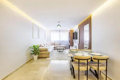 a living room with a table and a couch at Luxury 1BR in gueliz in Marrakech