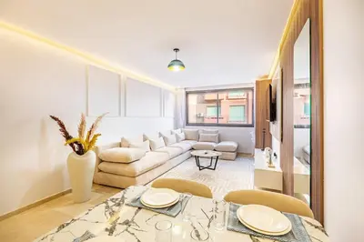 a living room with a white couch and a table at Luxury 1BR in gueliz in Marrakech