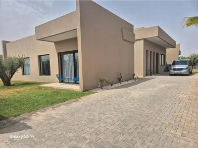 a house with a car parked in front of it at Beautiful Villa K&L in Marrakech