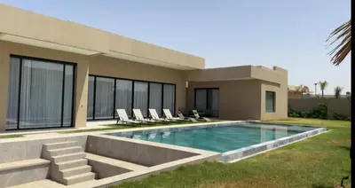 a house with a swimming pool in front of it at Beautiful Villa K&L in Marrakech