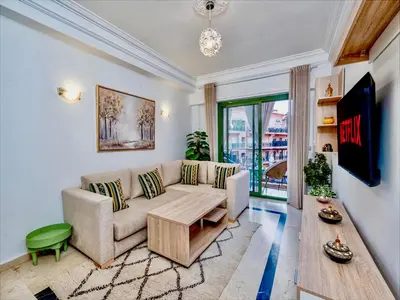 a living room with a couch and a table at Majorelle Appartement - Balcony and Netflix in Marrakech