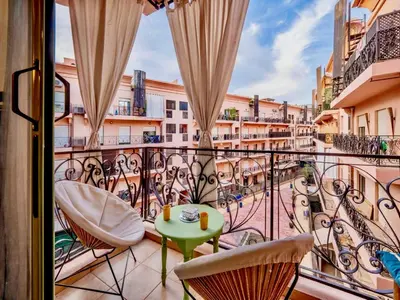 a balcony with chairs and a table on a balcony at Majorelle Appartement - Balcony and Netflix in Marrakech