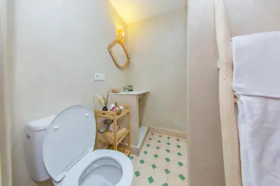 a bathroom with a toilet and a sink at Riad Dahab in Marrakech
