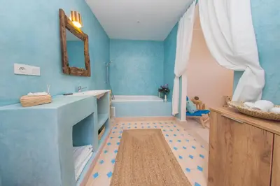 a blue bathroom with a sink and a tub at Riad Dahab in Marrakech
