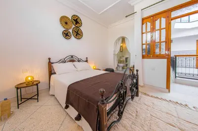 a bedroom with a bed and a clock on the wall at Riad Dahab in Marrakech