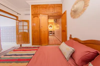 a bedroom with a bed and a door to a hallway at Riad Dahab in Marrakech