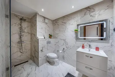 a bathroom with a toilet and a shower and a sink at Atlas view apartment in Marrakech