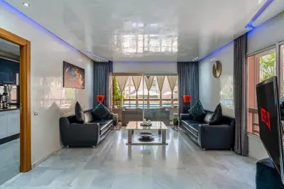 a living room with two couches and a coffee table at Atlas view apartment in Marrakech