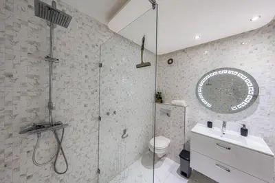 a bathroom with a shower and a toilet and a sink at Atlas view apartment in Marrakech