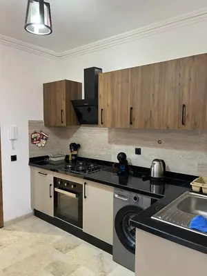 a kitchen with a stove and a sink at Appartement prestige gueliz in Marrakech