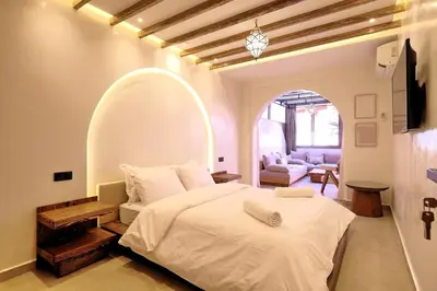 a bedroom with a large bed and an archway at Chic & Comfort, Experience Marrakech differently in Marrakech