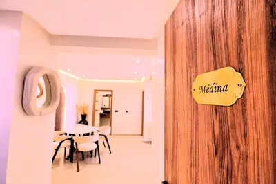 a dining room with a table and a sign on a wall at Chic & Comfort, Experience Marrakech differently in Marrakech