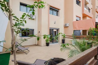 a balcony with a view of a building at 4BR Duplex - Jacuzzi - 10 min walk to M Avenue with Parking and Pool in Marrakech