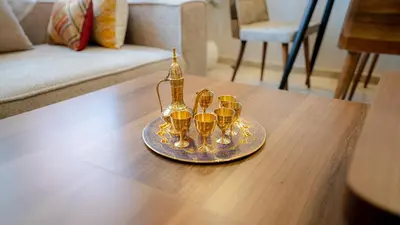 a tray with four gold candles on a table at Appartement 2 chambres à Marrakech - Résidence Soulaymane, in Marrakech