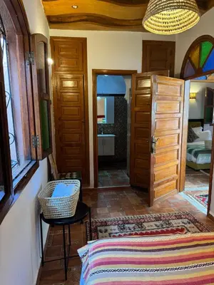 a bedroom with a bed and a room with a mirror at Riad Zahri 18 in Marrakech