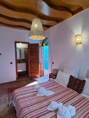 a bedroom with a bed with towels on it at Riad Zahri 18 in Marrakech
