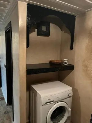 a washer and dryer in a small room at Dar Azélia - Charming riad with terrace & pool near Medina in Marrakech