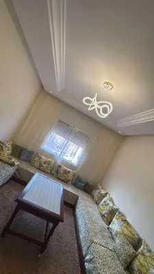a living room with a couch and a table at Les Amandiers in Marrakech