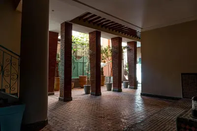 an empty hallway with brick columns in a building at studio au centre ville marrakech calme et confort in Marrakech