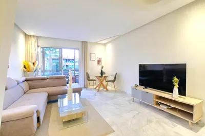 a living room with a couch and a flat screen tv at Exceptional stay in Marrakech, Comfort & Style in Marrakech
