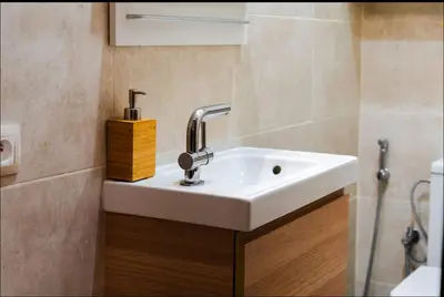 a bathroom with a white sink and a shower at Gueliz BEST Residence Nour!! 3 Bedrooms Large Modern Apartment, walking distance to train station and everything in Marrakech