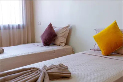 a room with two beds with pillows on them at Gueliz BEST Residence Nour!! 3 Bedrooms Large Modern Apartment, walking distance to train station and everything in Marrakech