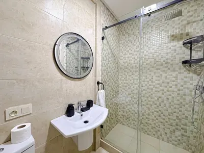 a bathroom with a sink and a glass shower at Cocon à Marrakech avec balcon in Marrakech