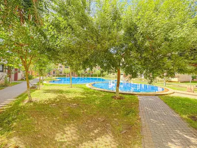 a swimming pool with trees in a park at Cocon à Marrakech avec balcon in Marrakech