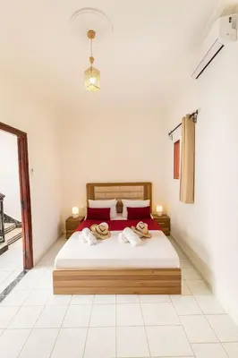 a bedroom with a bed with two towels on it at Riad Mounad with pool - close to Jemaa el-fna in Marrakech