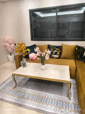 a living room with a couch and a coffee table at Appartement moderne au cœur de Marrakech in Marrakech