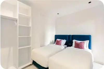 two beds sitting next to each other in a room at Wonderful & Warm in City Center in Oulad Akkou