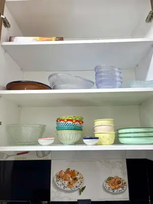 a white shelf with bowls and plates on them at Wonderful & Warm in City Center in Oulad Akkou