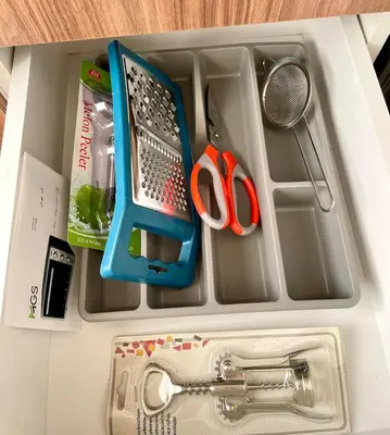 a drawer filled with kitchen utensils and other items at Wonderful & Warm in City Center in Oulad Akkou