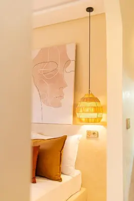 a room with a painting of a woman at Central apartment plus jacuzzi in Marrakech
