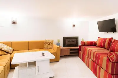 a living room with two couches and a tv at Studio mezzanine cosy près de Jemaa el-Fna in Marrakech