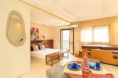 a room with a bed and a table with a mirror at Excellent apartment plus hot tub in Marrakech