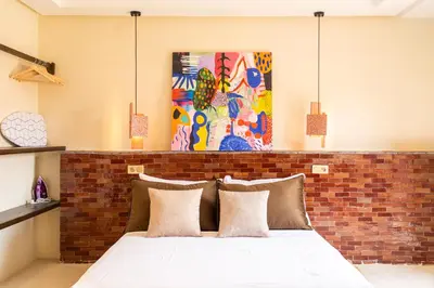 a bedroom with a brick wall and a bed with pillows at Excellent apartment plus hot tub in Marrakech