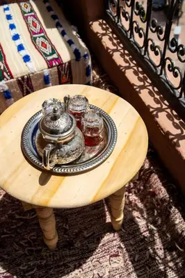 a wooden table with a tray of food on it at Excellent apartment plus hot tub in Marrakech