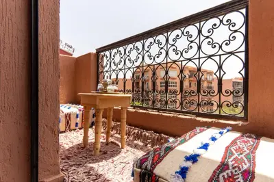 a balcony with a table and a view of a building at Excellent apartment plus hot tub in Marrakech