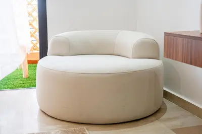 a white chair sitting in a living room at œil de la vallée in Marrakech