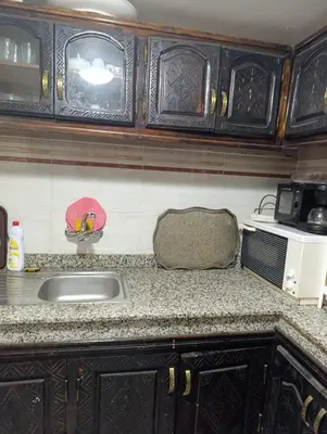 a kitchen counter with a sink and a microwave at Riad kech residence al Qarya syahiya Marrakech in Marrakech