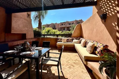 a patio with a couch and a table at Al Qantara with Terrace and Pool in Marrakech
