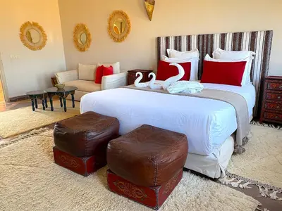 a bedroom with a large bed with swans on it at Palais Khemia in Marrakech