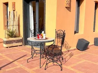 a table and chairs sitting on a patio at Palais Khemia in Marrakech