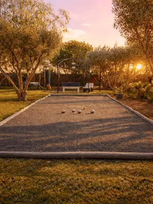 a park with a playground with a bench and balls at Palais Khemia in Marrakech