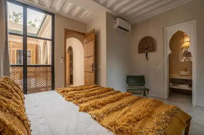 a large bed in a room with a large window at Riad Tassili Vert in Marrakech