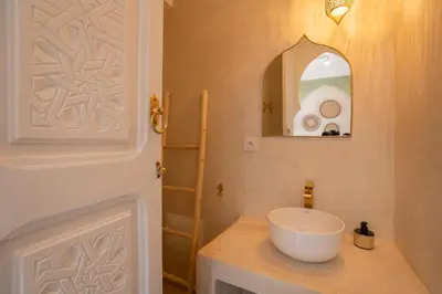 a bathroom with a white sink and a mirror at Riad Tassili Vert in Marrakech